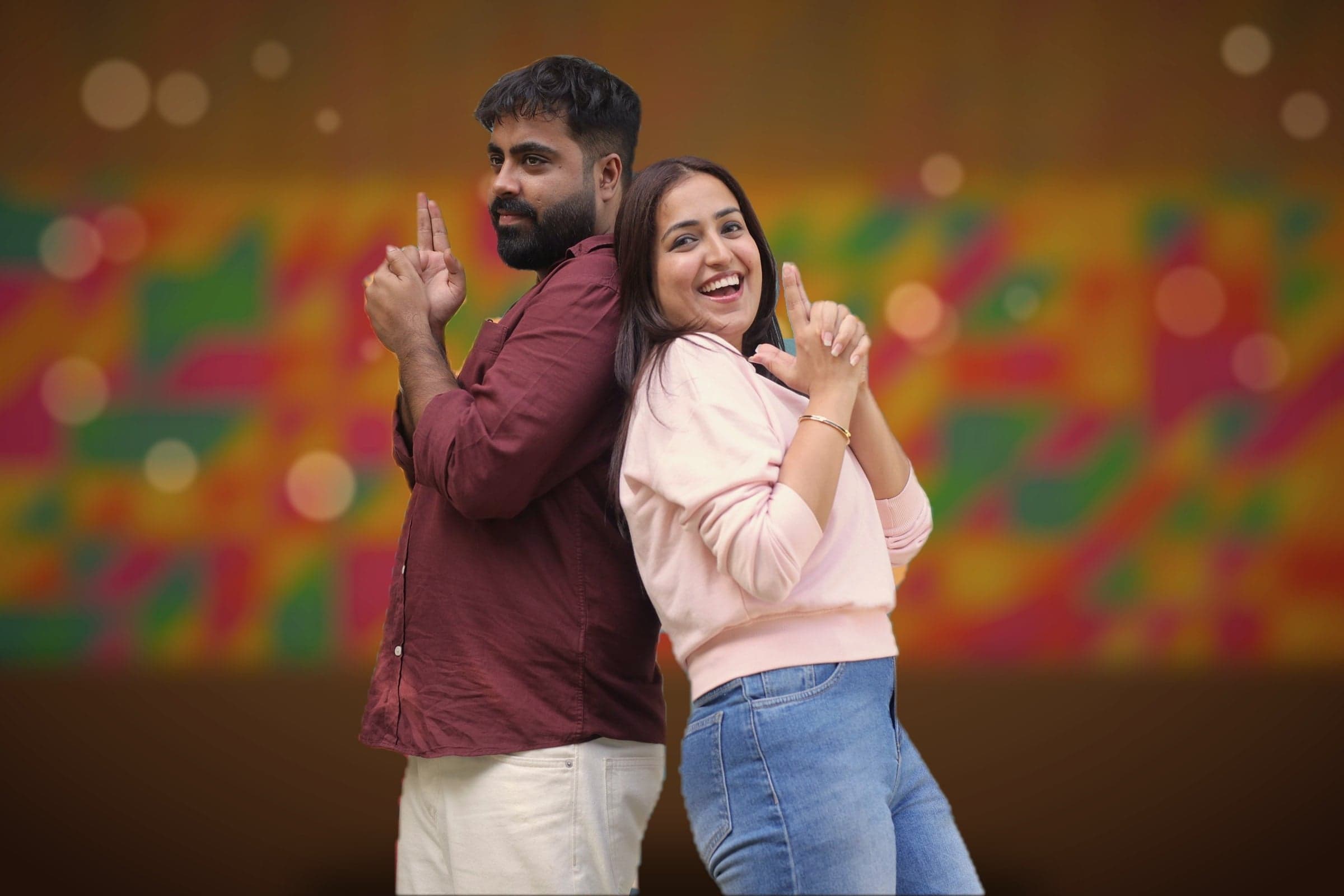 Disha and Mayank standing back to back, laughing